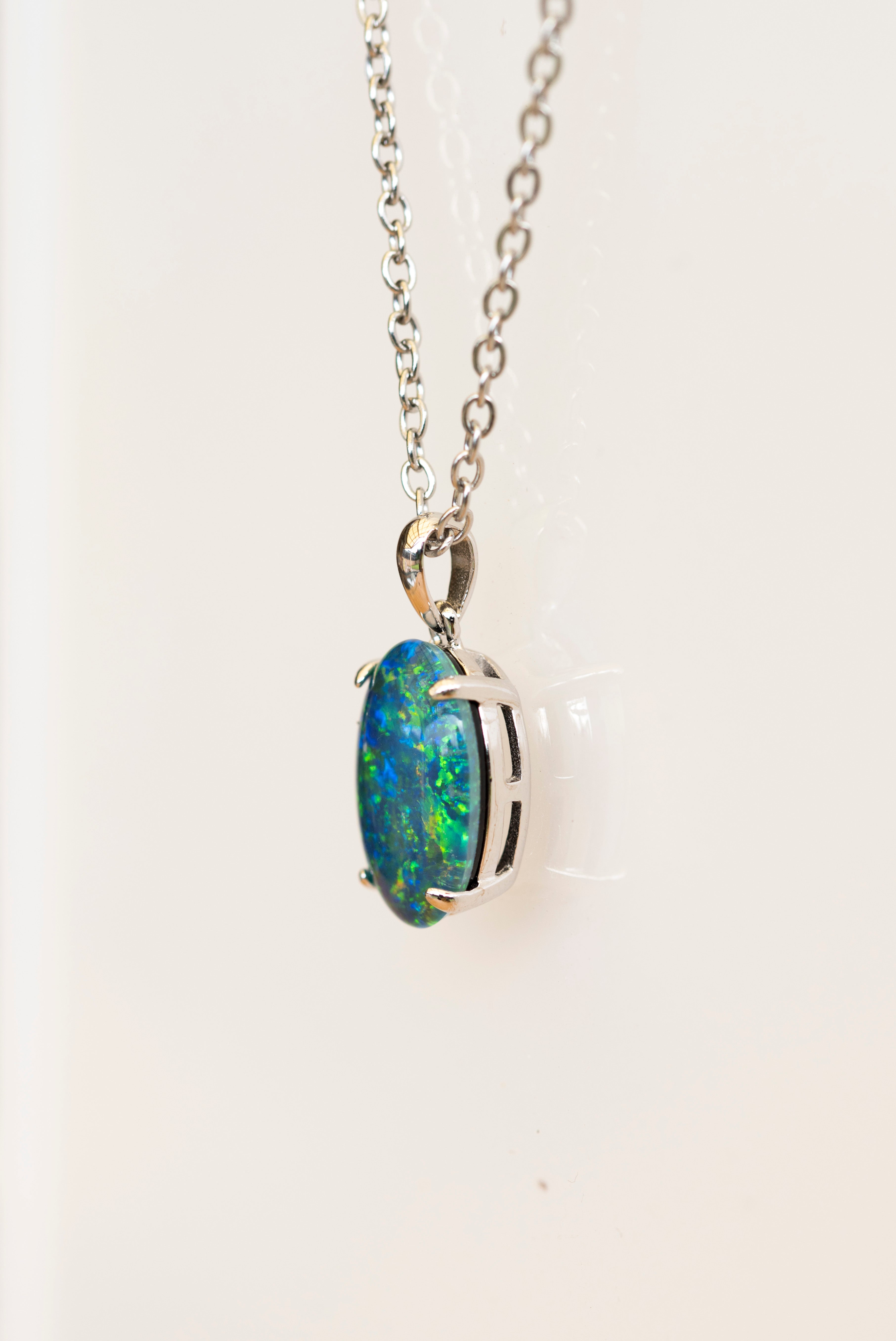 Opal pendant necklace on a white background
