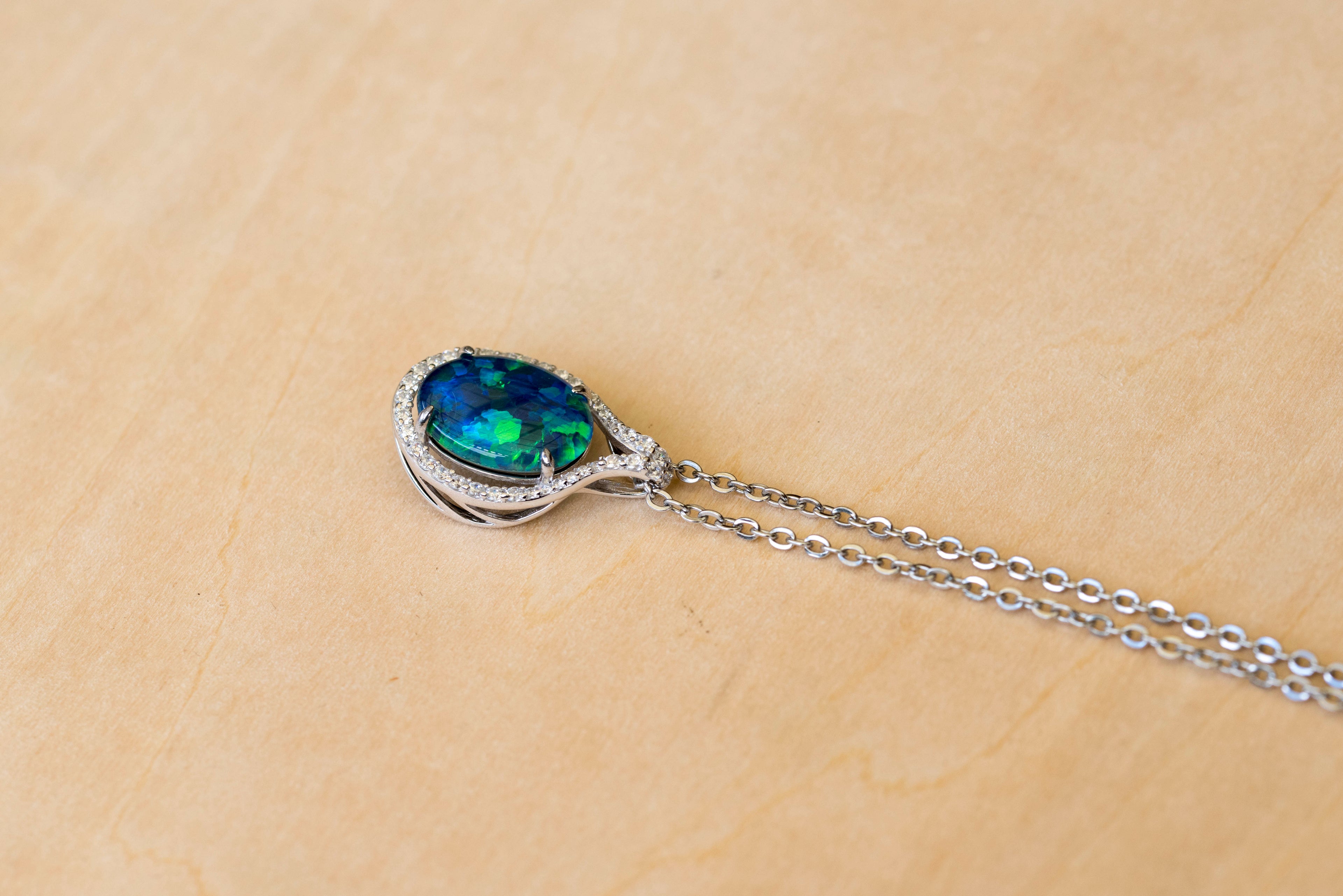 Necklace with an opal pendant on a beige background