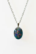 Opal pendant necklace on a white background