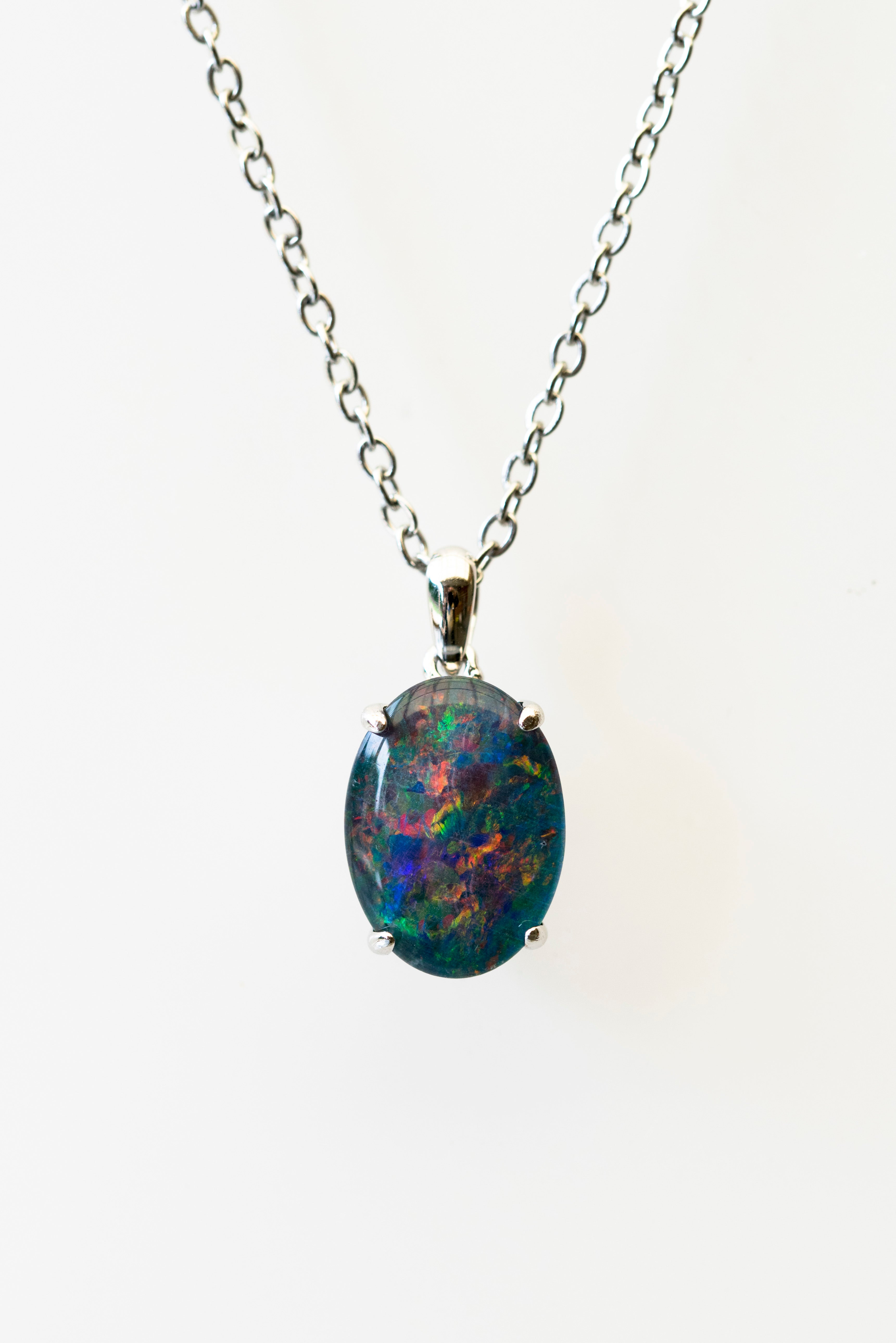 Opal pendant necklace on a white background