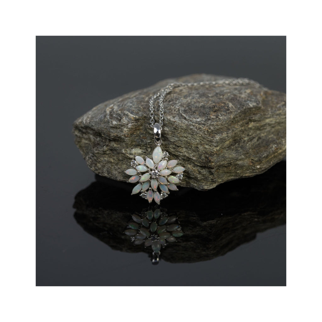 Necklace with a floral pendant on a rock