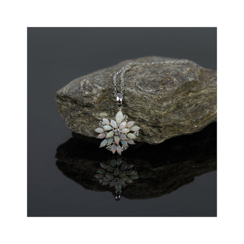 Necklace with a floral pendant on a rock