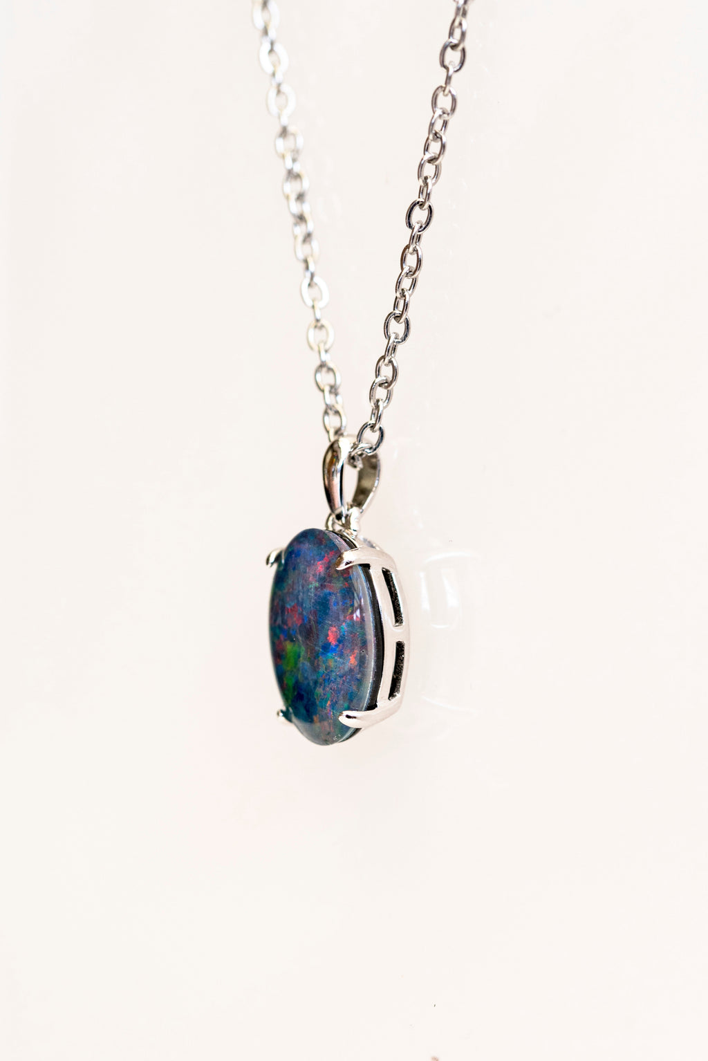 Opal pendant necklace on a white background